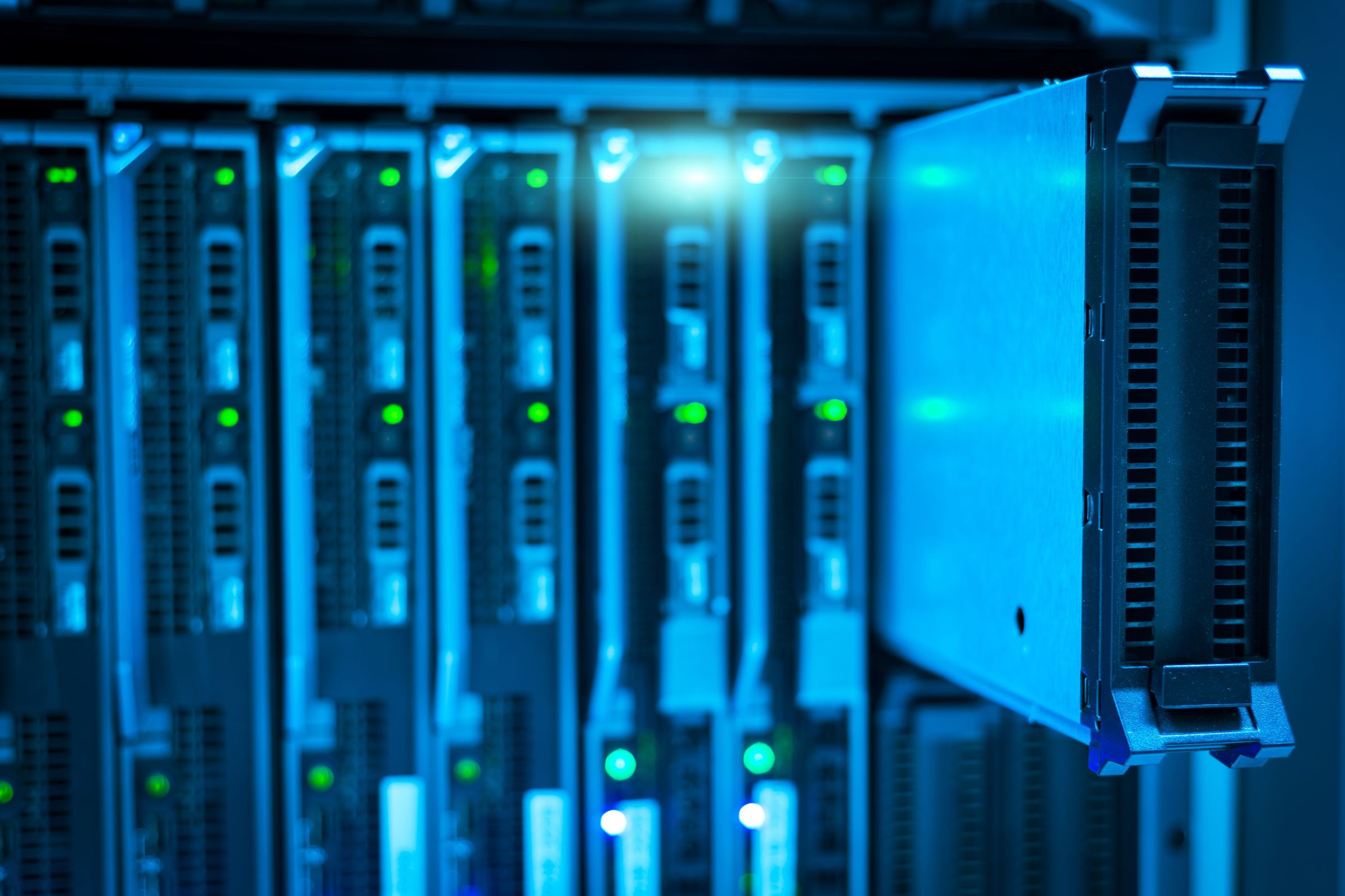 Blade server chassis lit blue inside a data centre rack