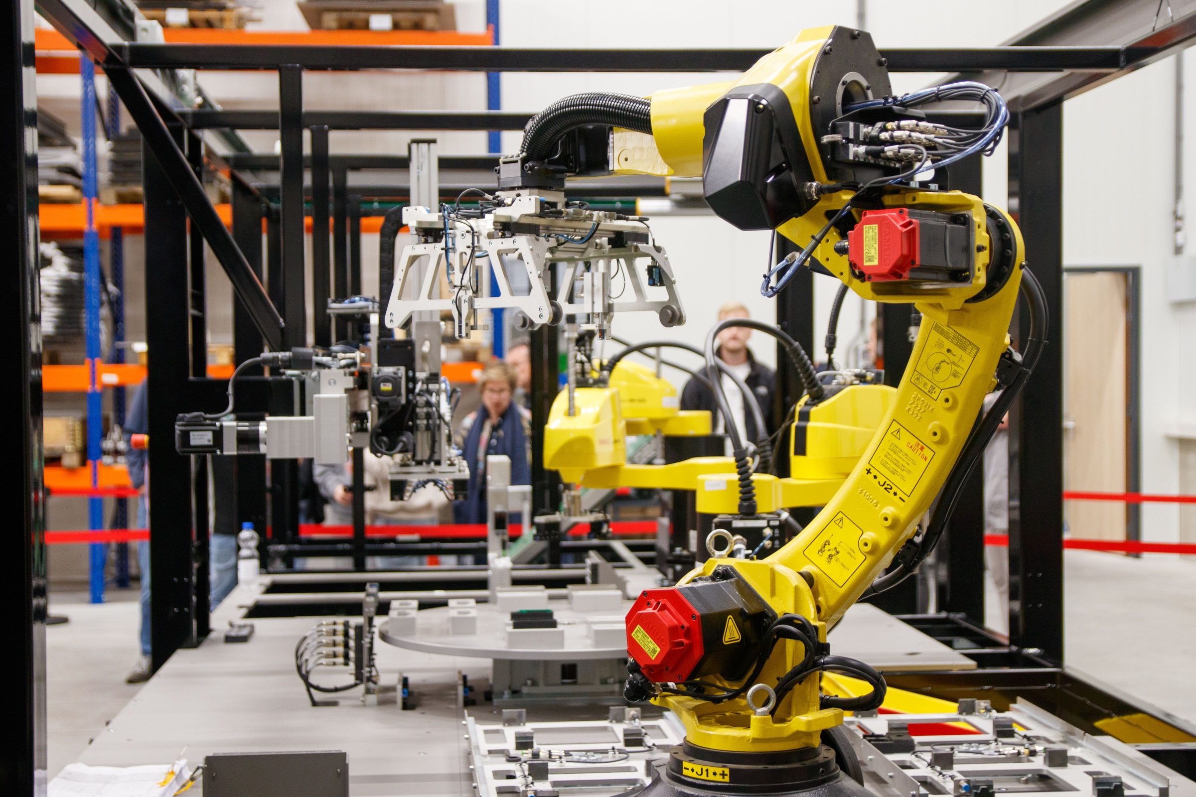 Industrial robot arm working in a bright automated production facility