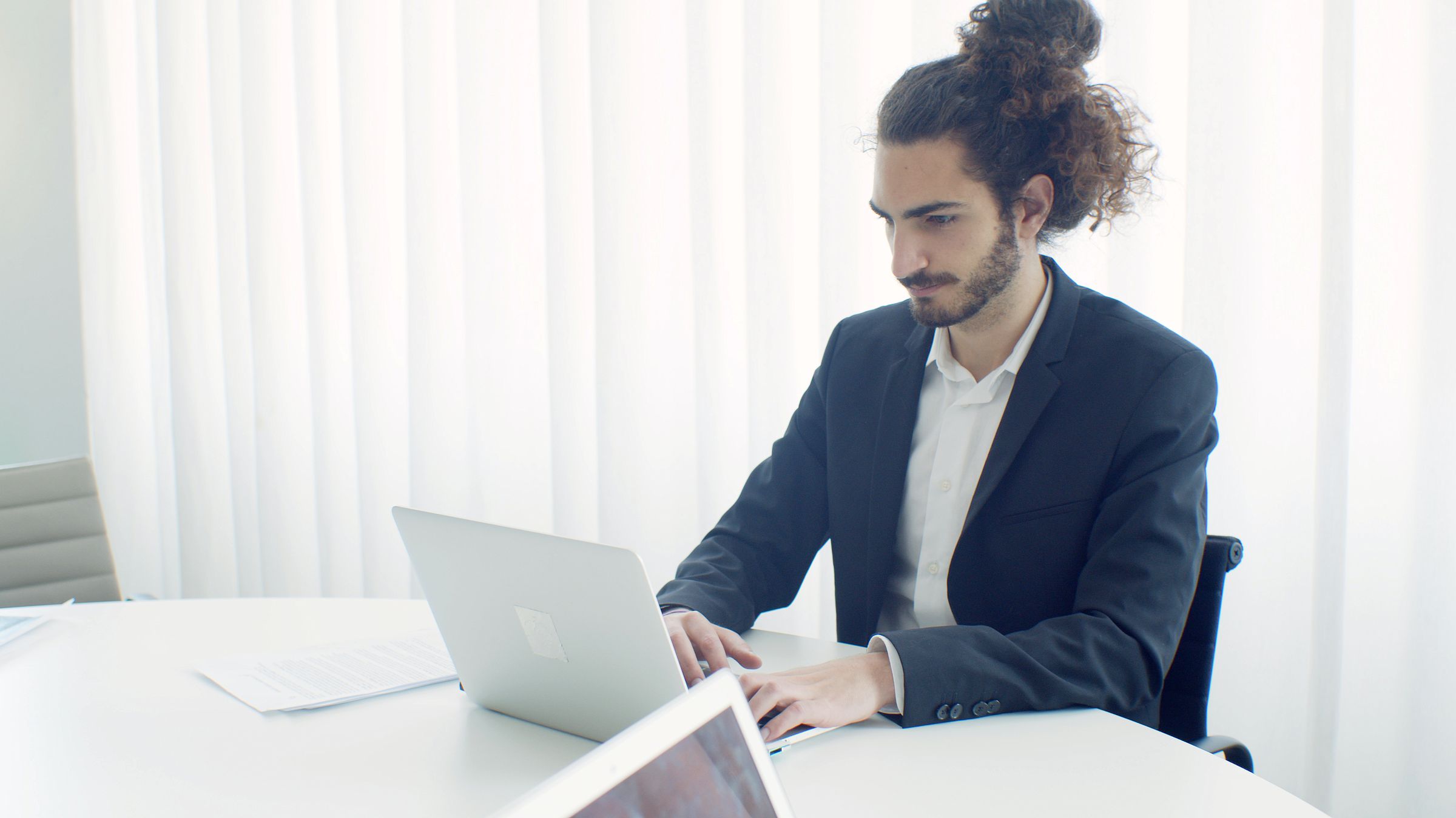 Tool integration and process automation, shown as a professional connecting business tools on a laptop in a bright office
