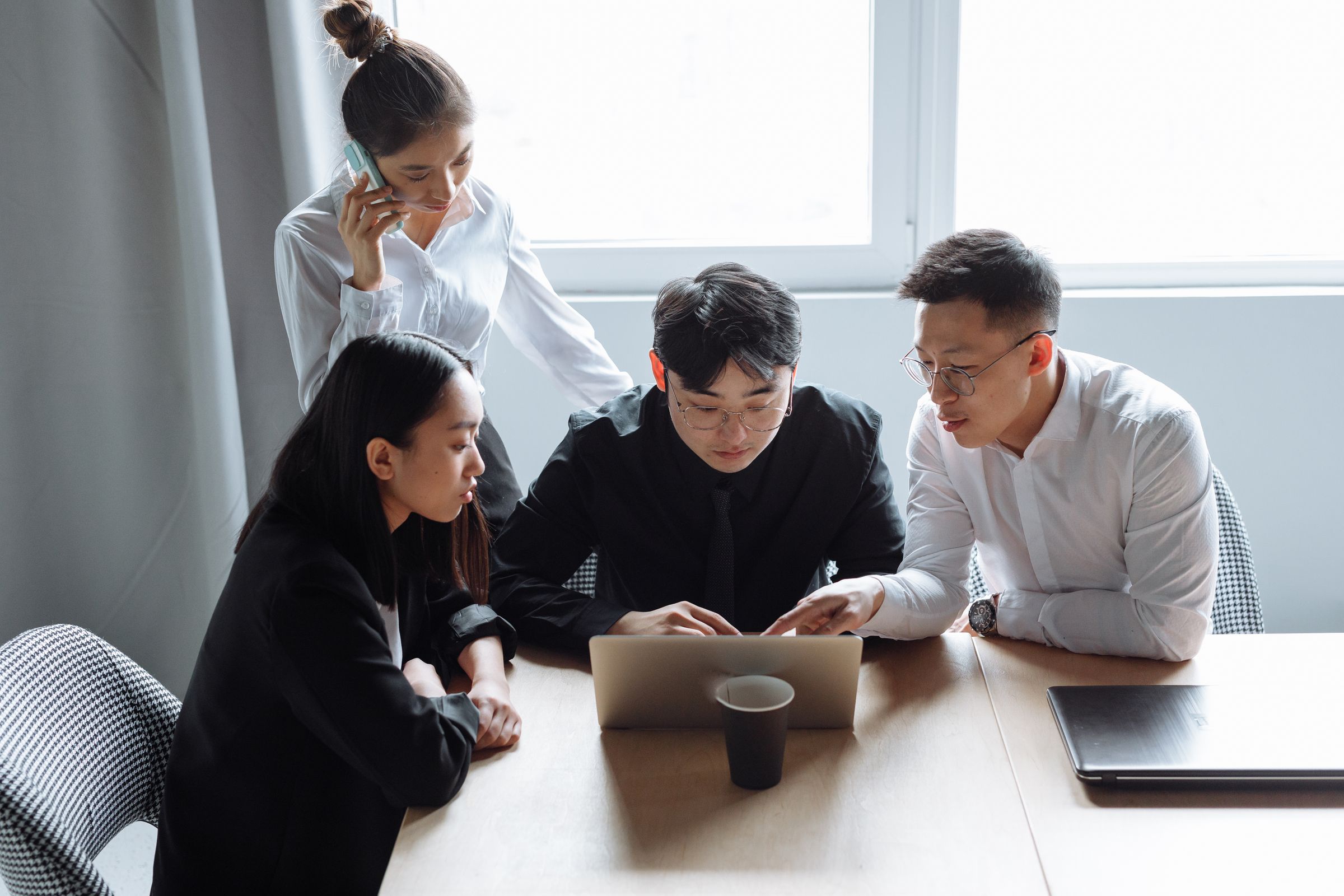Team reviewing their CRM together at a laptop