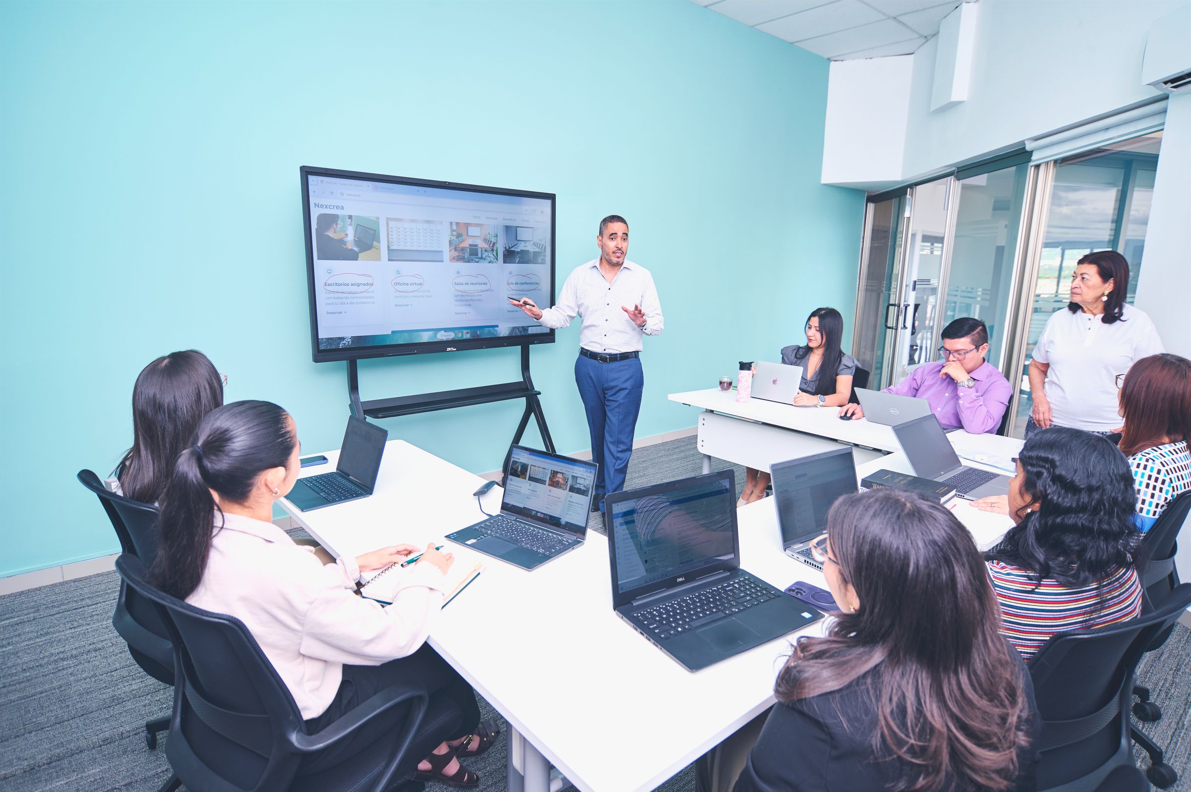India GCC team onboarding session, with a leader presenting to colleagues at laptops