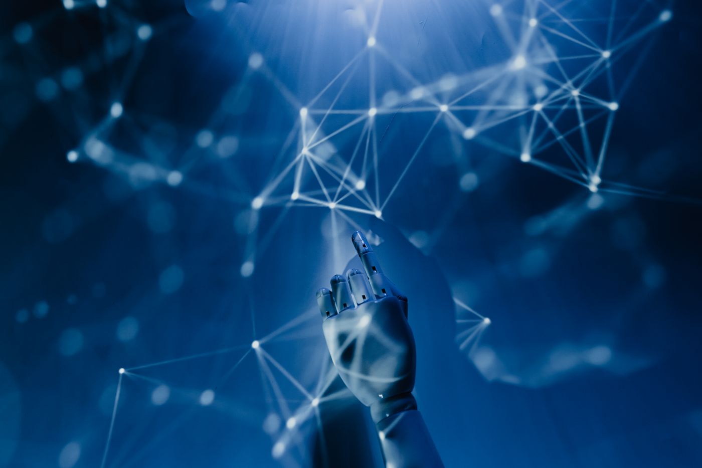 Robotic hand reaching into a network of connected points