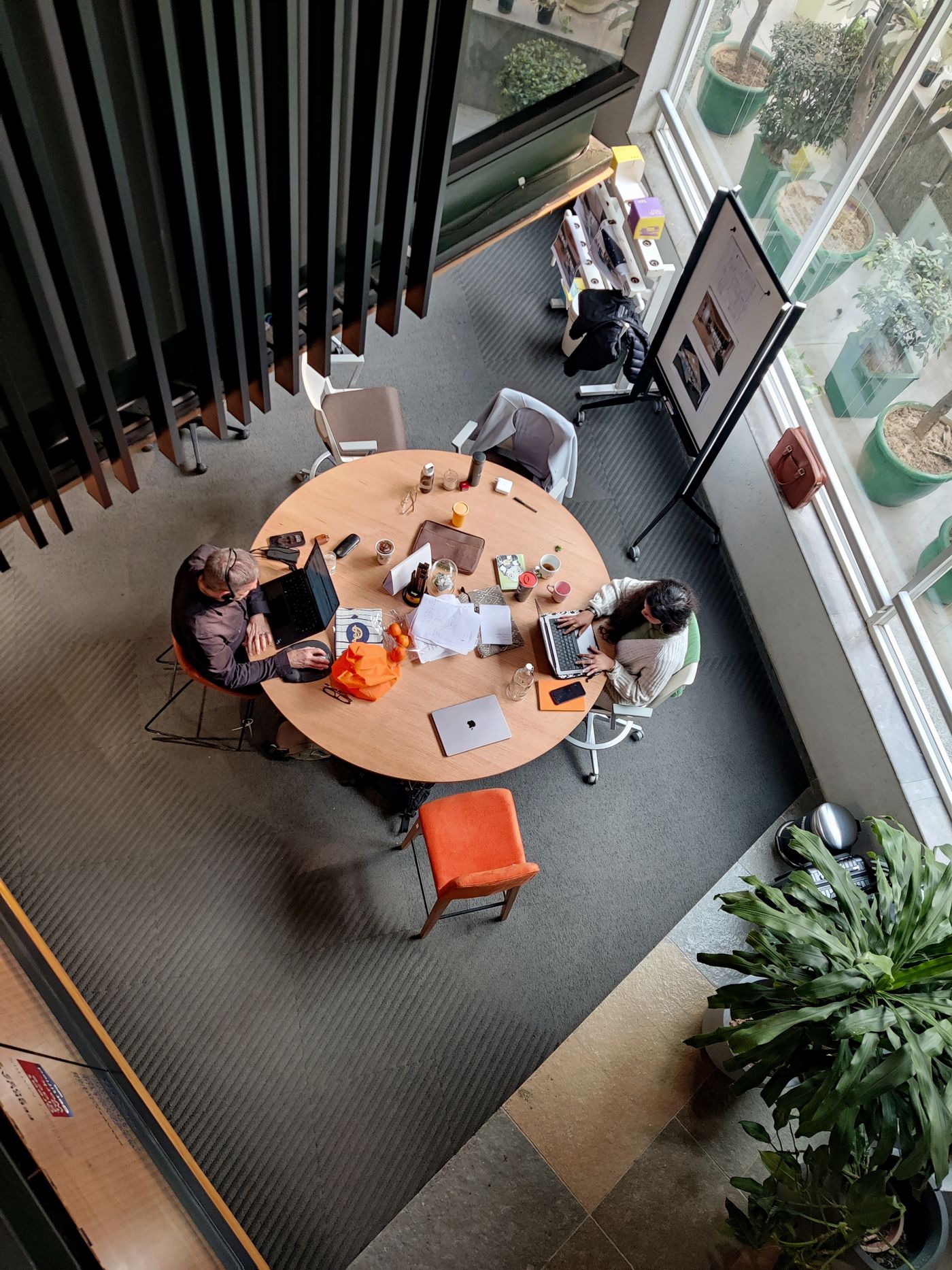 Overhead view of a team collaborating around a table in a modern office