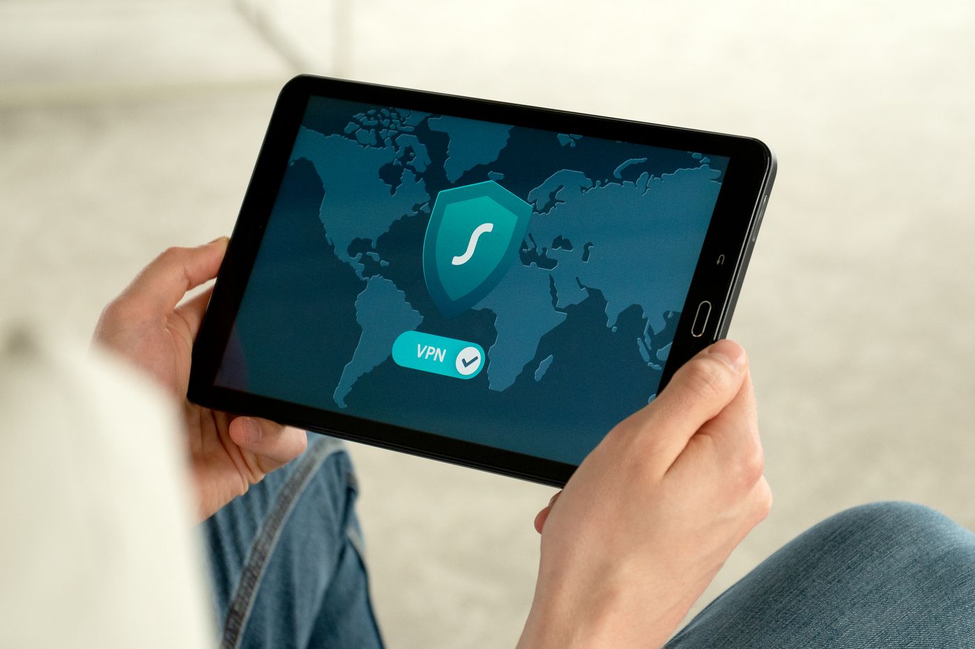Tablet showing a security shield over a world map