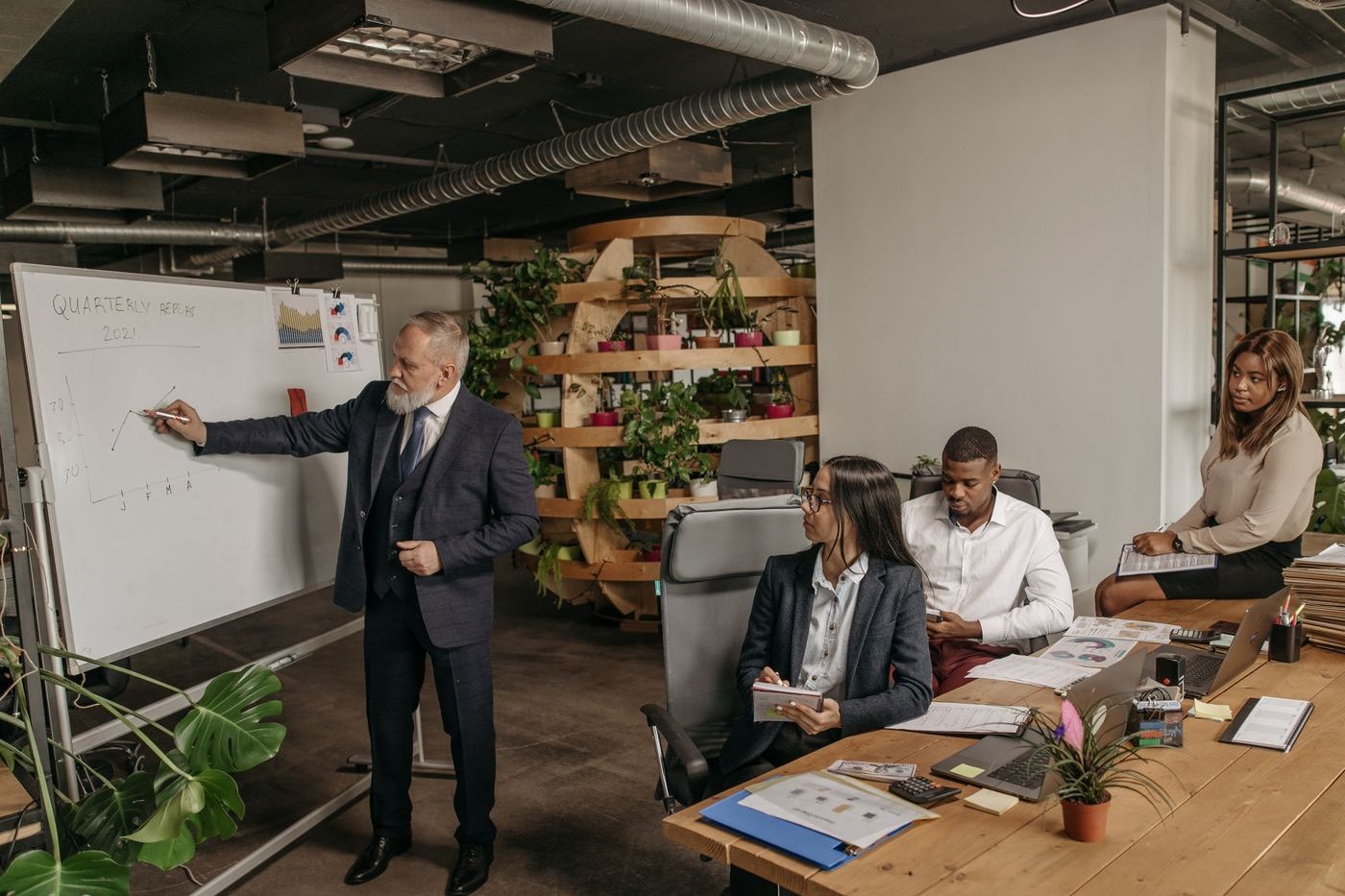Revenue team gathered around a presentation in an open-plan office