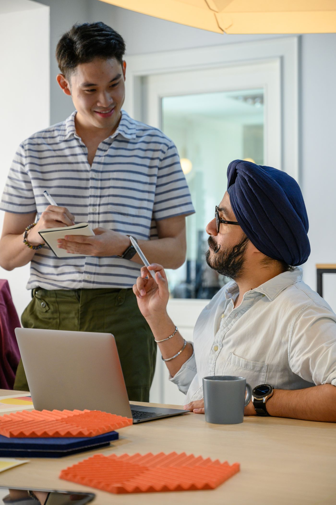 Engineer reviewing work on a tablet with a colleague