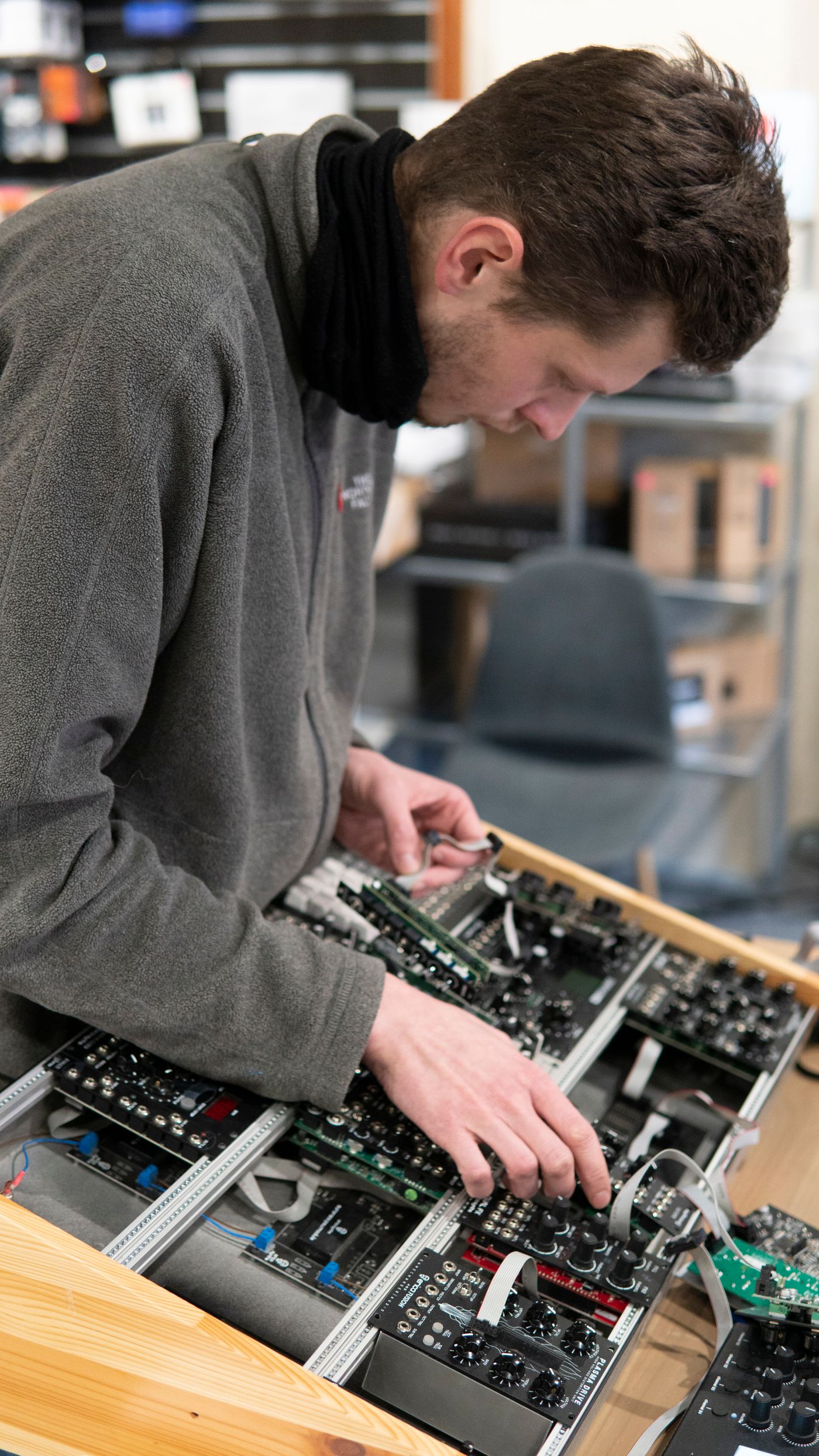 Technician assembling circuit boards on a workbench