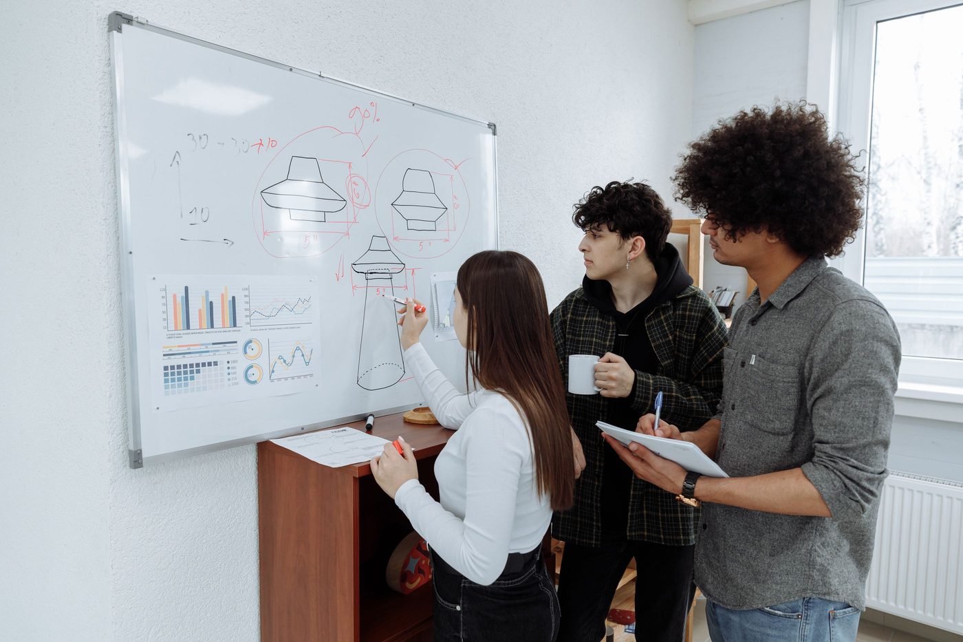 Team reviewing a system diagram on a whiteboard