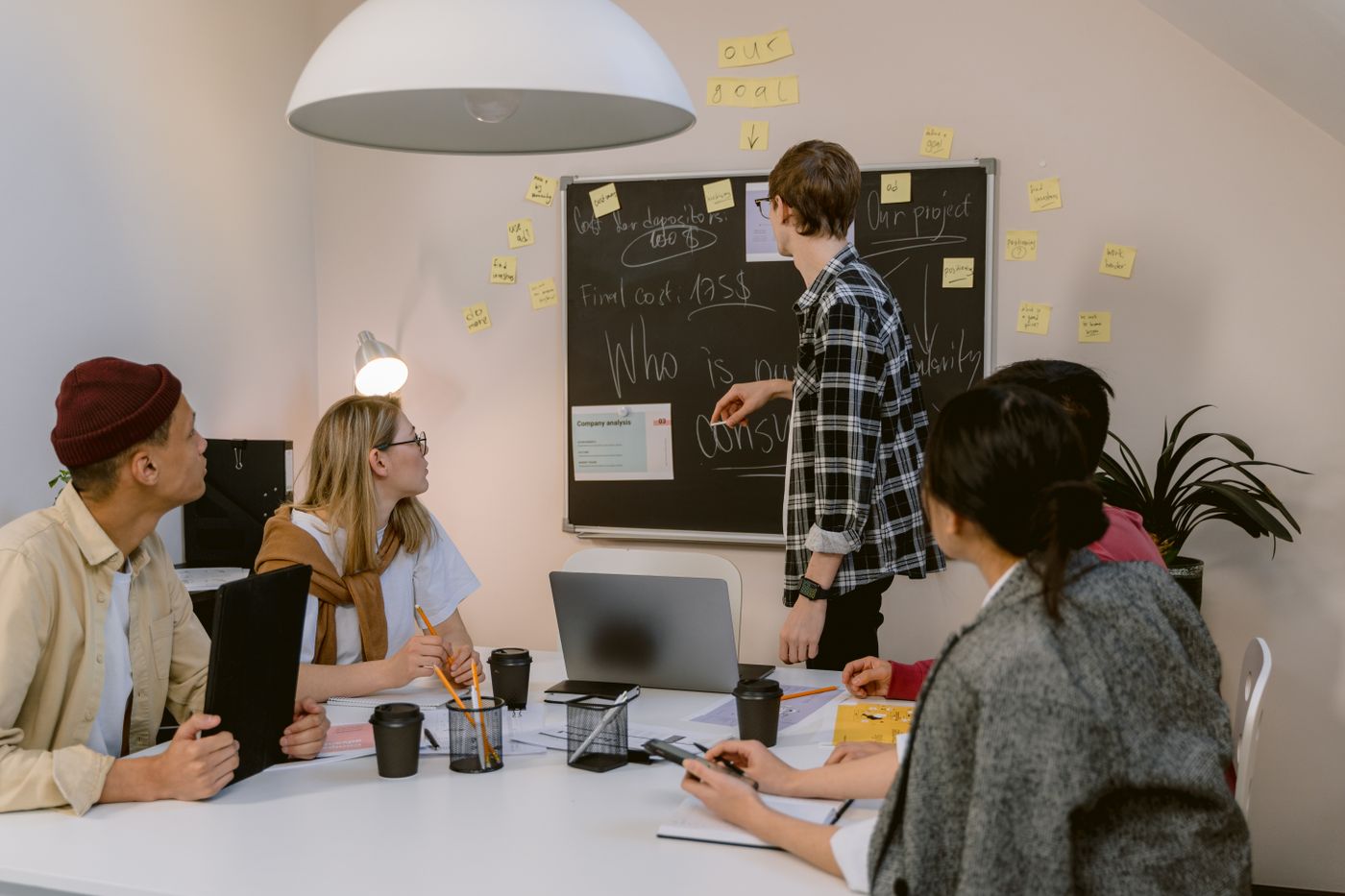 Team mapping a CRM architecture on a chalkboard
