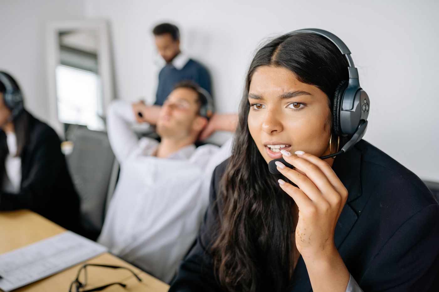 Sales rep working in a newly configured CRM on her headset