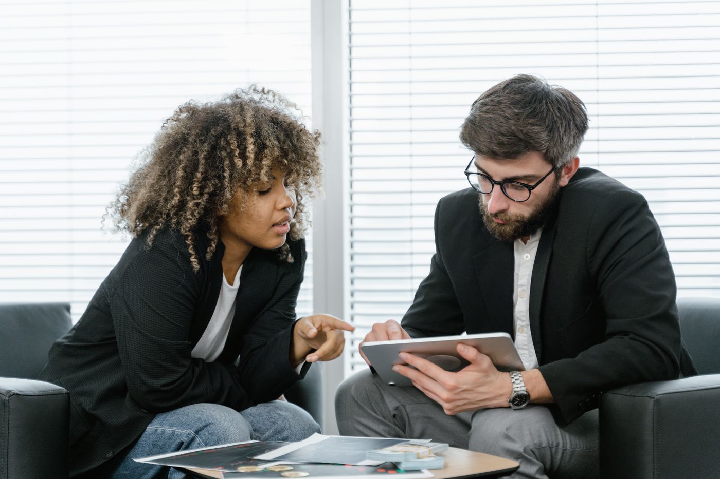 Two colleagues reviewing customer details on a tablet