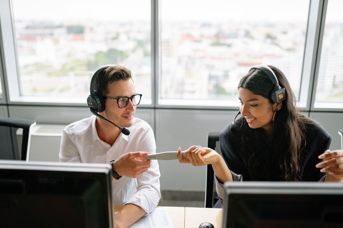Service agents with headsets working a customer case together