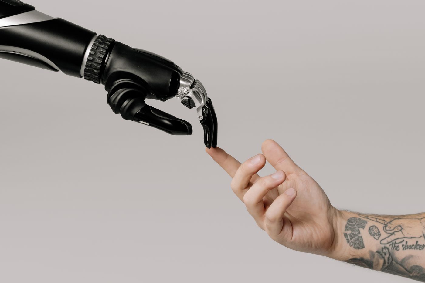 Human hand reaching toward a robotic hand