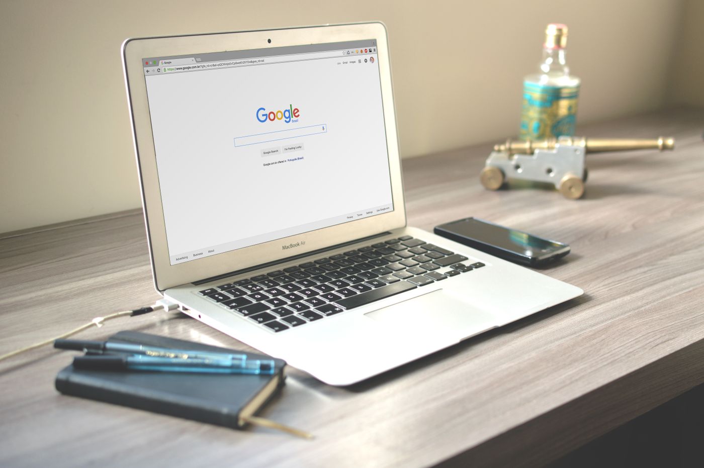 Laptop open to a search page beside a notebook