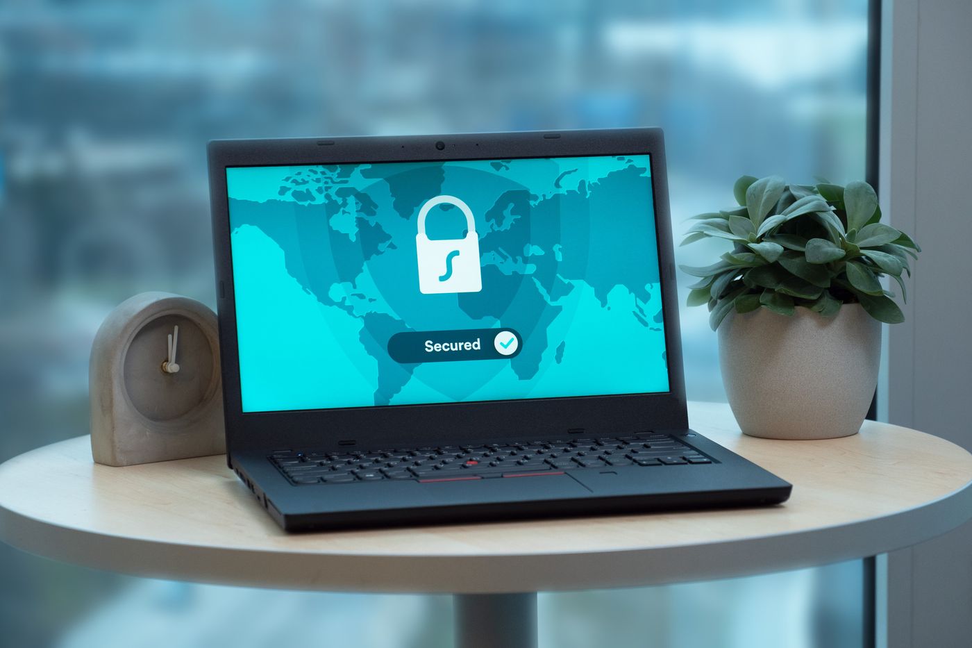 Laptop showing a padlock security screen on a café table