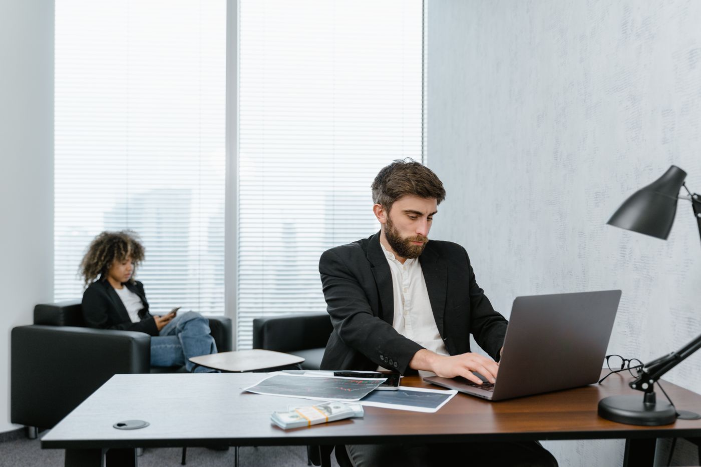 Professional working through leads on a laptop in a bright office