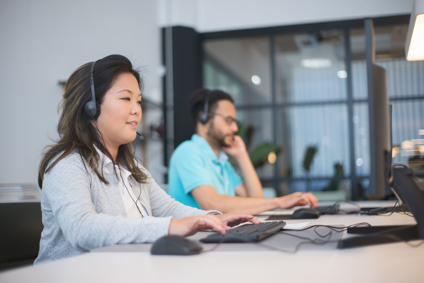 Sales team working their prioritized leads at computers