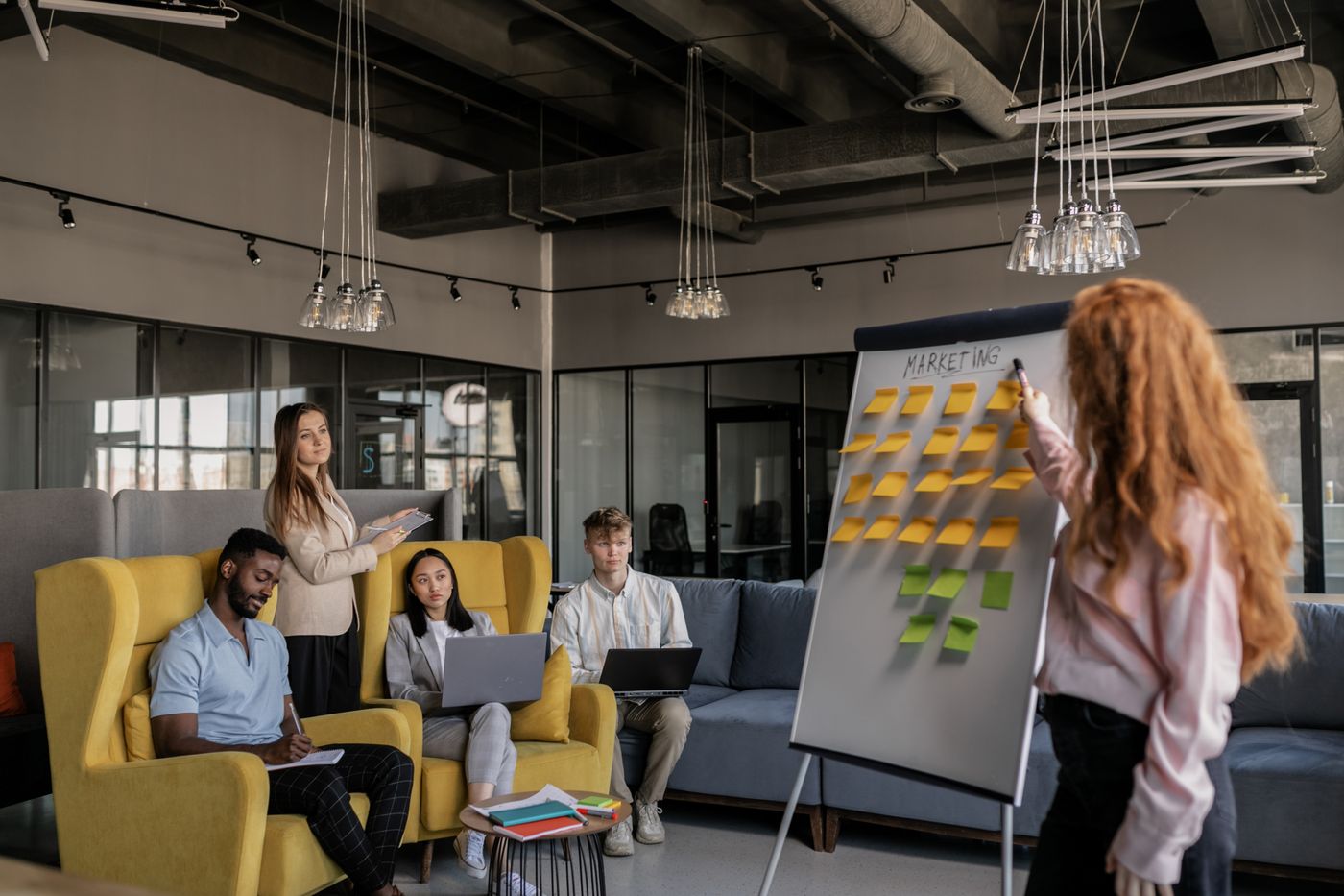 Team designing a revenue process on a board of sticky notes