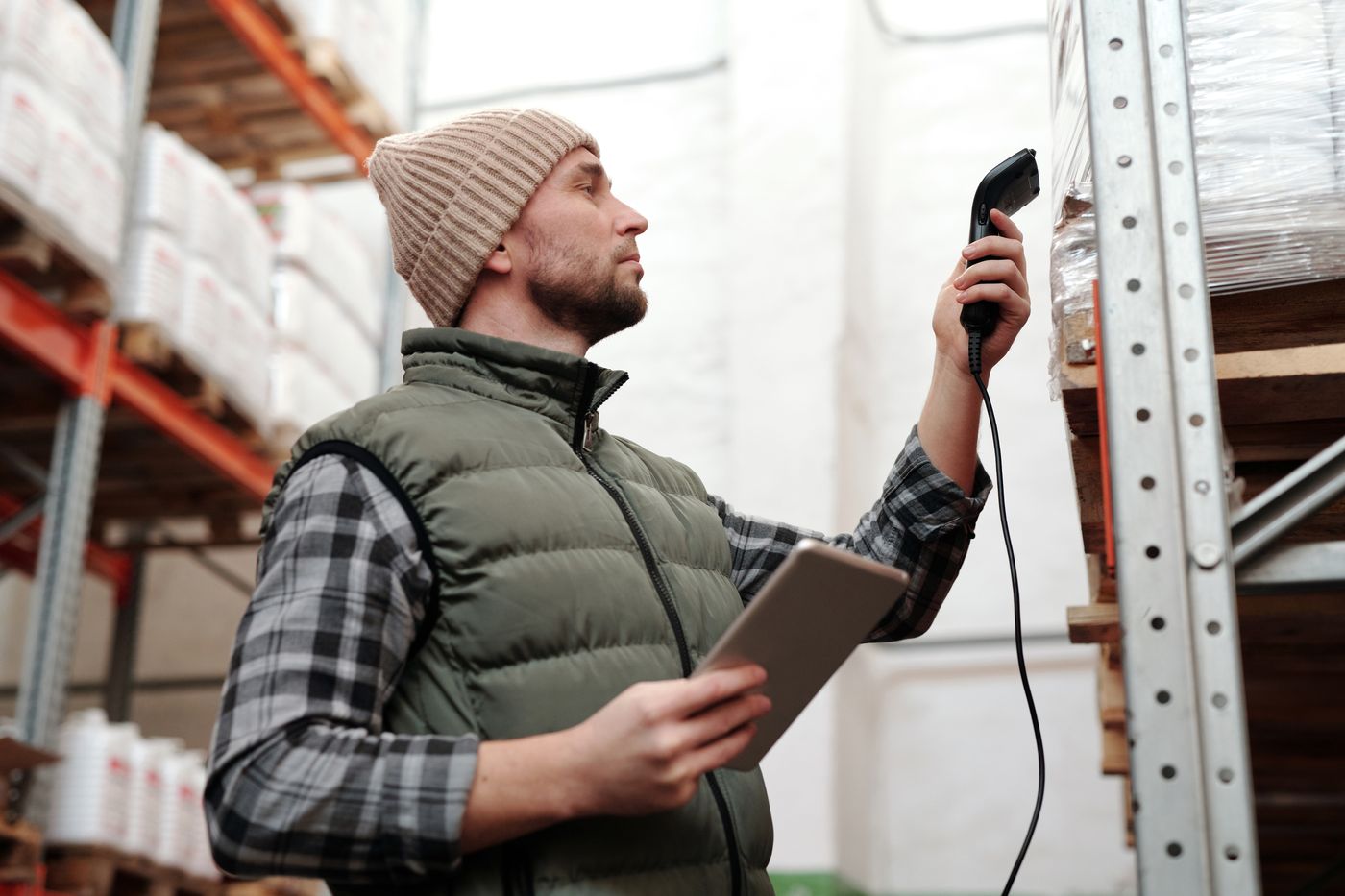 Warehouse worker scanning stock on a shelf, creating an inventory event