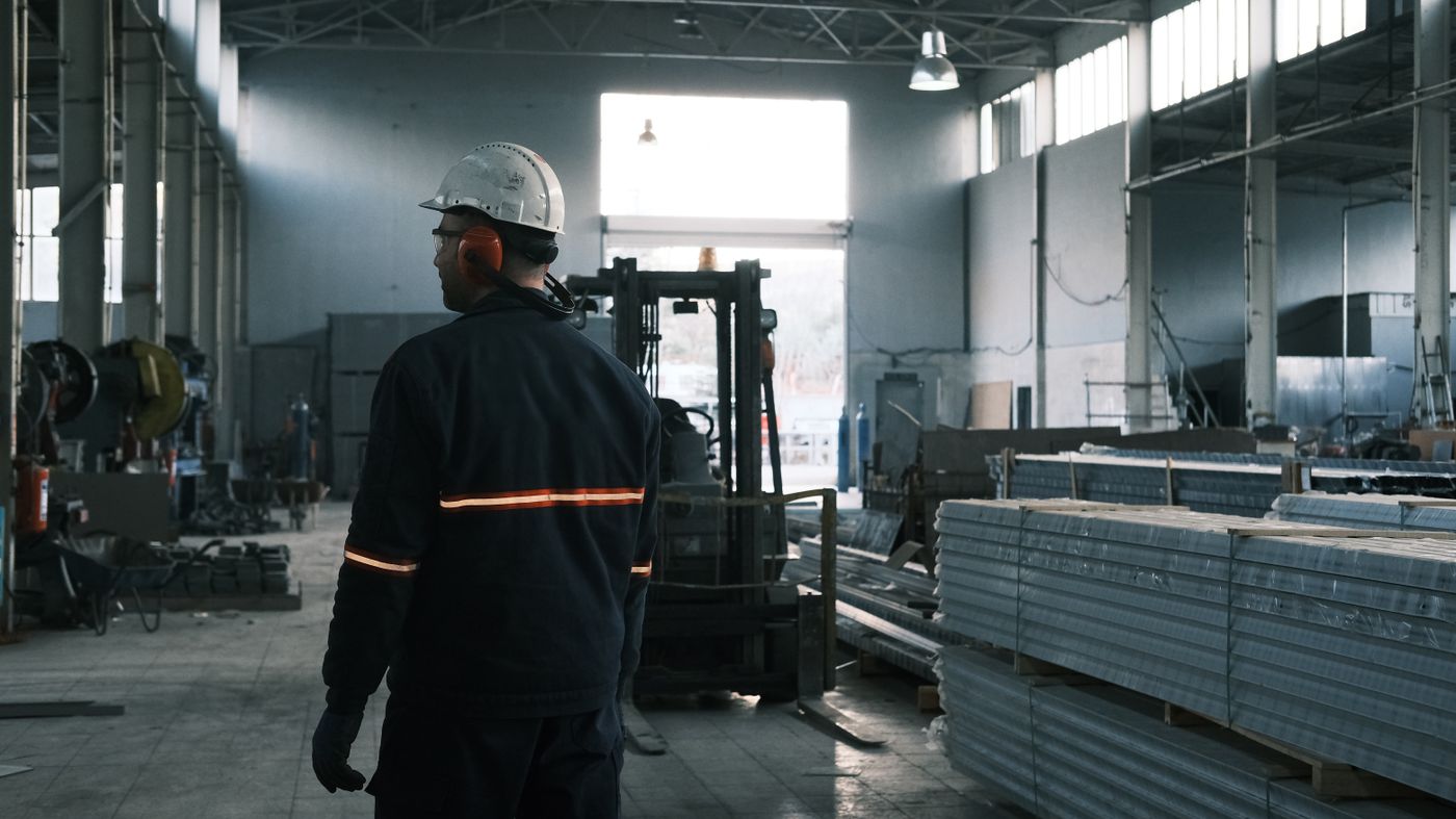 Worker walking through a metal fabrication plant