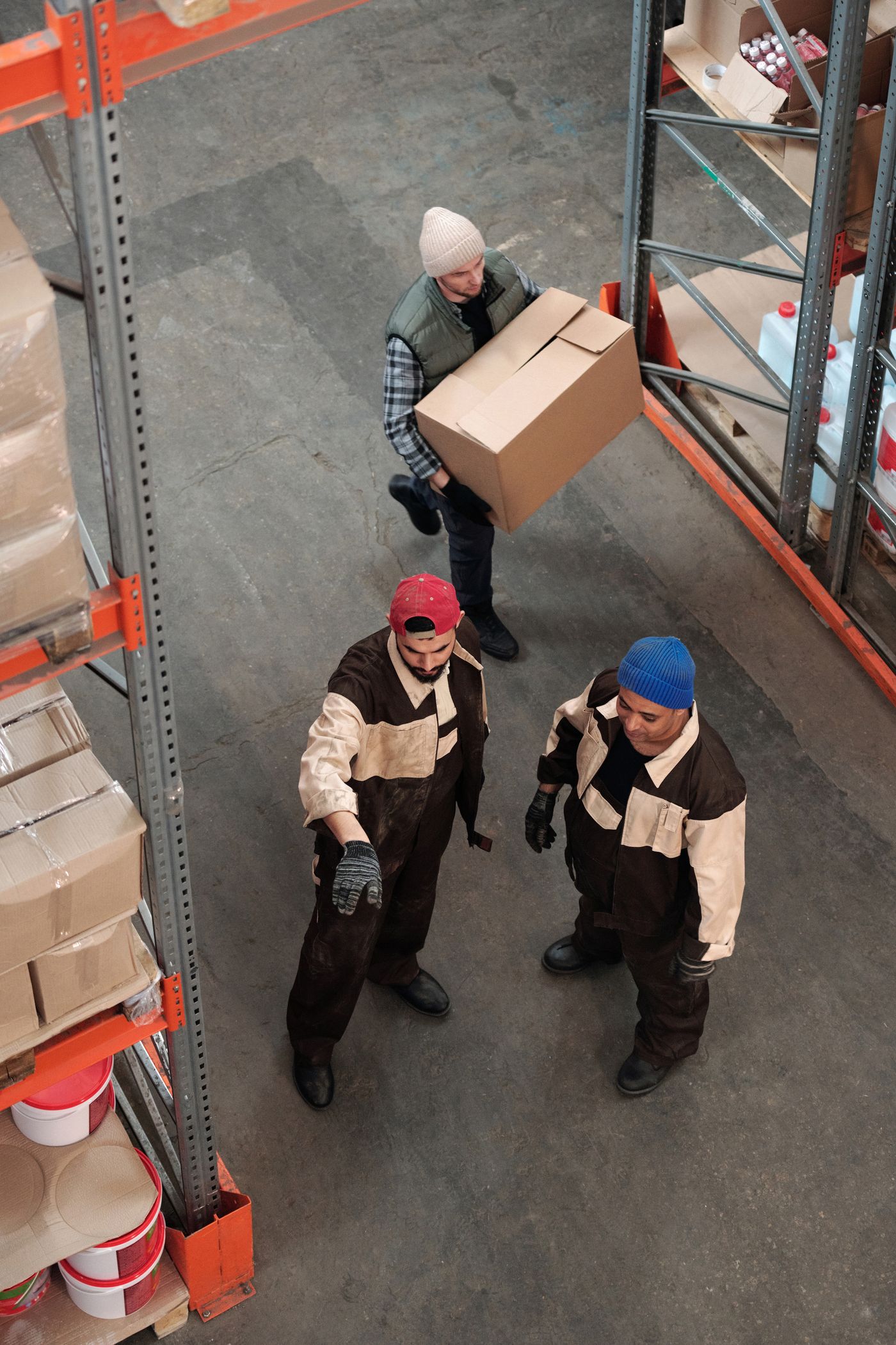Warehouse team moving boxes along a storage aisle
