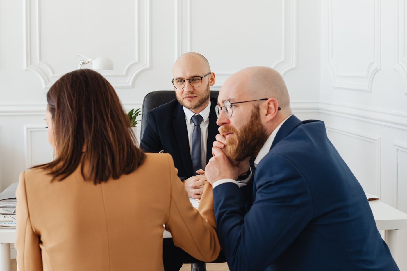 Advisers meeting with a client across a desk