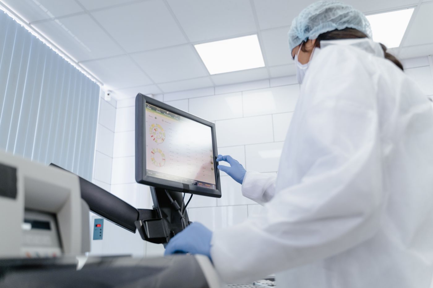 Lab technician at a monitor in a laboratory