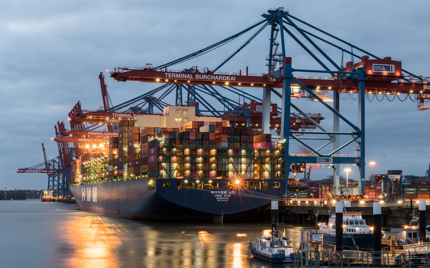 Container ship moored at a port terminal at dusk