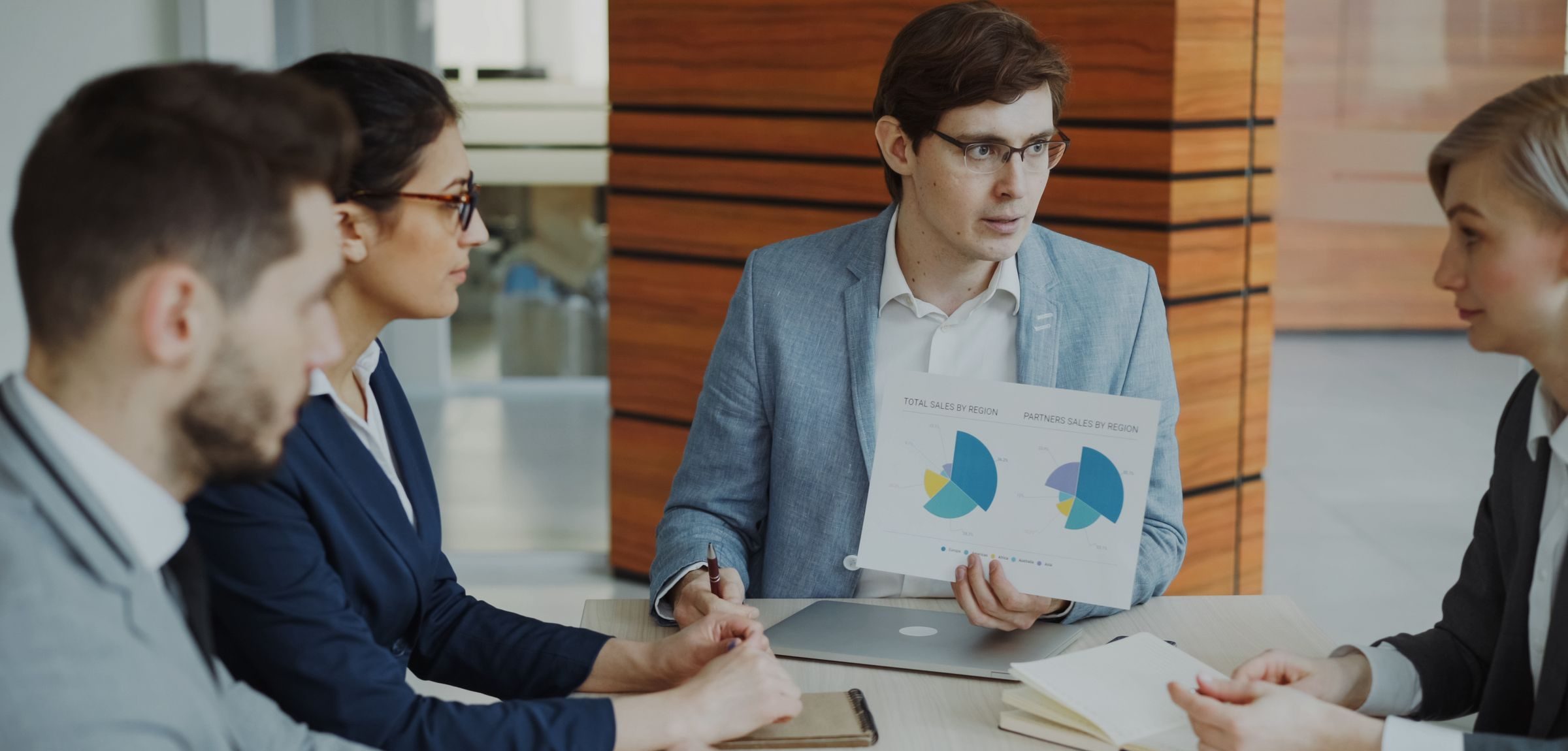 Sales team reviewing buyer data charts together in a meeting